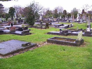 location of William’s unmarked grave, in the triangle of grass nearest the camera, with a general view beyond.