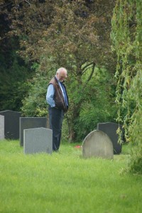 Rod Teale reads some of the Methodist headstones.