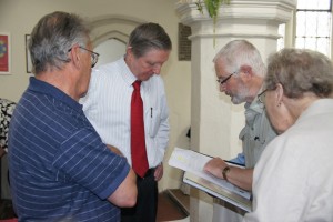 Ewart checks the paperwork with Alan Gibb.